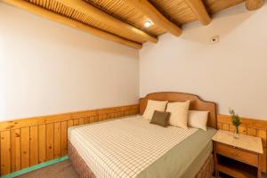 a bedroom with a bed in a room at Primrose Cottage, 1 bhk Villa w garden by Roamhome in Leh