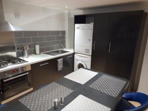 a kitchen with a cross on the floor at North Laine Deluxe Apartment sleeps 6 in Brighton & Hove