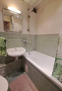 a bathroom with a bath tub and a sink at Volvi Apartment in Tallinn