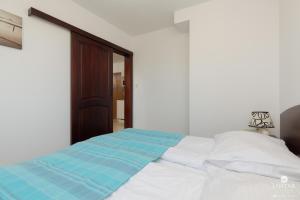 Posteľ alebo postele v izbe v ubytovaní Jantar Apartamenty City Center