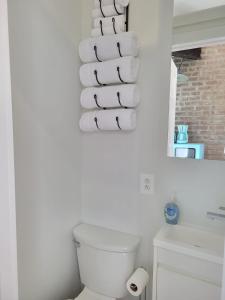 a white toilet sitting next to a white wall at Harlem Lodge in New York