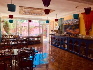 a restaurant with tables and chairs and a bar at Malabata Guest House in Tangier