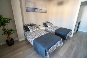 מיטה או מיטות בחדר ב-Cabildo Spa 1