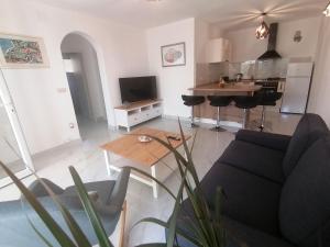 a living room with a couch and a table at House FIDULIĆ - apartment RUSTIC in Lumbarda