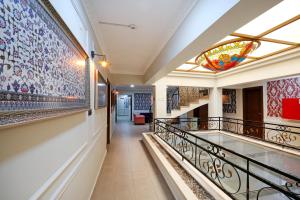 a hallway with mosaics on the walls and a stained glass window at URLA PERA HOTEL in Urla