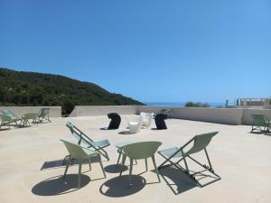 a group of chairs and tables on a roof at HMO Glamping & Suites in Vignanotica in Mattinata