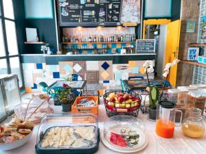 a table with food on a counter in a restaurant at Ostello Bello Napoli in Naples