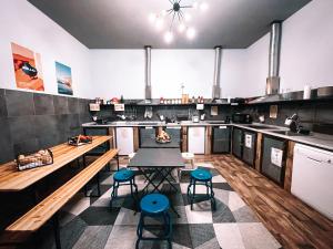a large kitchen with a table and chairs in it at Ostello Bello Napoli in Naples +48 photos