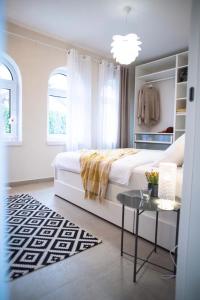 a bedroom with a large bed and a table at Todor boutique house in Sremska Kamenica +32 photos