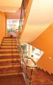 a staircase with a metal railing in a house at HOTEL PHILOXENIA in Eforie Nord