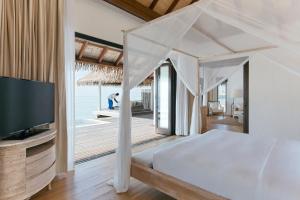 Postel nebo postele na pokoji v ubytování COMO Maalifushi