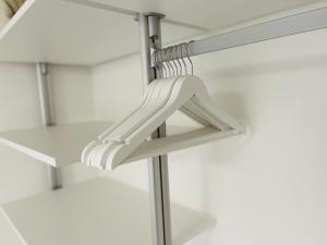 a white hanger in a closet with white shelves at Ferienwohnung in Stockach am Bodensee in Stockach