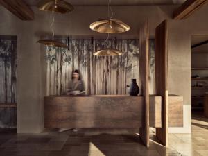 a person is standing in a room with a wall at Acro Suites - A Wellbeing Resort in Agia Pelagia +37 photos