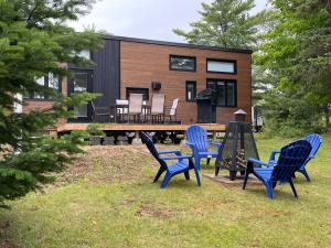 a group of blue chairs in front of a house at La Magnolia in Saint Zenon