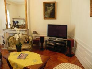 a living room with a television and a table at Villa MONIKA in Dieppe