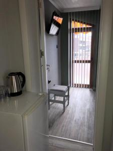 a kitchen with a table and a chair and a refrigerator at Семейна къща “Вълчеви” in Kiten