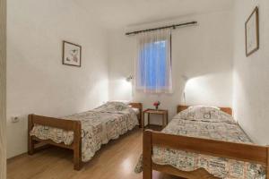Postel nebo postele na pokoji v ubytování Apartments Vila Catic