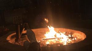 a person is standing in front of a fire at Los Sunchos Casa de Campo in Ataliva