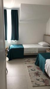 a bedroom with two beds and a window at La Foresteria in Galşa