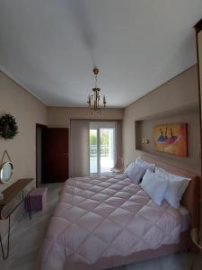 a large bedroom with a large bed in it at La maison de Catherine in Volos