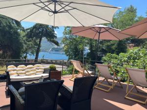 a patio with a table and chairs and umbrellas at Apartments Vojvoda in Kotor