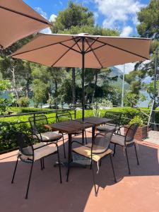 a wooden table and chairs with an umbrella at Apartments Vojvoda in Kotor