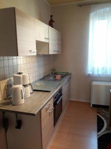 a kitchen with white cabinets and a counter top at FeWo LoBec in Calau