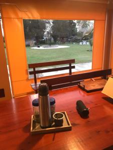 a tray with a coffee maker and a bench in a room at Los Sunchos Casa de Campo in Ataliva