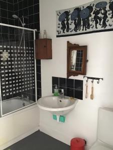 a bathroom with a sink and a shower and a tub at Gallery Flat in Newburgh