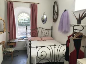 a bedroom with a black bed and a window at Gallery Flat in Newburgh