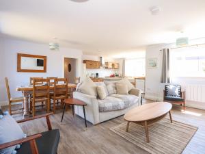 a living room with a couch and a table at Samphire in Skegness