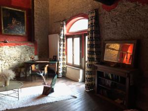 a living room with a large window and a table at Vacanze in Baita di charme Alta Val di Susa Oulx in Savoulx