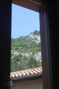 a view of a mountain from a window at Torrente Rosandra in San Dorligo della Valle +12 photos