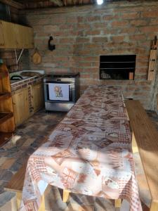 a kitchen with a table with a blanket on it at Casa elmar in Canela
