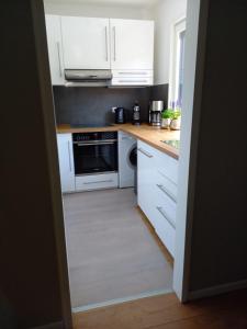 a kitchen with white cabinets and a stove top oven at THE IVY in Wittingen +7 photos