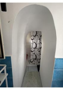 a hallway with an archway in a room with blue tiles at Amalfi Coast Casa Ida in Vietri sul Mare