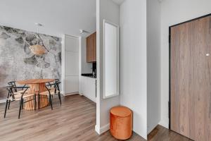 una cucina e una sala da pranzo con tavolo e sedie di Gdańsk Comfort Apartaments Łąkowa a Danzica