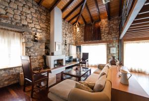 a living room with a couch and a table at Villa La Strada in Afitos