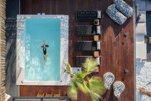an overhead view of a woman in the water in a swimming pool at Casa Negro in Rethymno Town +42 photos