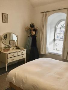 a bedroom with a bed and a dresser and a mirror at Gallery Flat in Newburgh