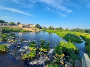 an aerial view of a river with rocks at Cottage Room- Agroturystyka in Strzegowo-Osada