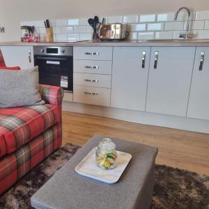 a living room with a couch and a table with a plate at The Ramleh in Scarborough