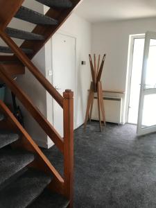 a room with a staircase and a wooden chair at Beautiful Holiday Home in Schull in Schull