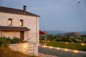 a brick house with lights on the side of it at Villa de Vino in Ioannina