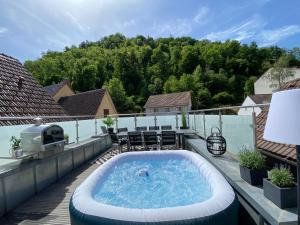 a deck with a hot tub on a patio at Haus Schiltach in Schramberg