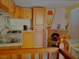 a kitchen with a sink and a stove top oven at Da Greta - Biassa in La Spezia