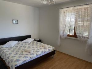 a bedroom with a bed and a window at Valica Gardens in Savudrija