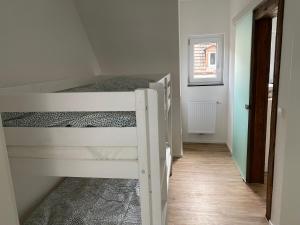 a bedroom with two bunk beds and a hallway at Haus Schiltach in Schramberg