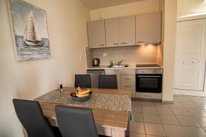 a kitchen with a dining room table with a boat on it at Castri Village Hotel in Palekastron