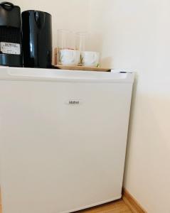 a white refrigerator with a shelf on top of it at Budget Room Tjuvholmen in Oslo